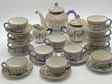 a lot of cups and saucers that are sitting on a table
