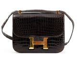 brown leather handbag with gold hardware on the handle
