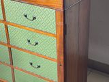a green and brown dresser in a room with tile flooring