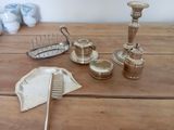 a wooden table with a lot of silver objects on it