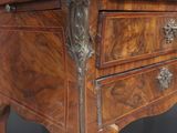 a small wooden table with a drawer on top of it