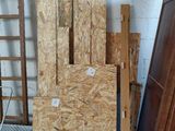 several pieces of plywood are stacked on top of each other in a room