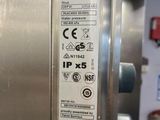 a close up of a stainless steel refrigerator with a sticker on it