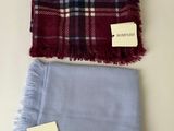 a scarf and a scarf tag on a white surface