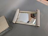 a mirror on the wall of a bathroom with a toilet in it