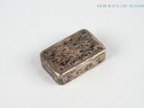 a silver box with a design on it on a white surface