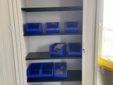 an open cupboard with bins and bins in it