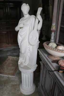 a statue of a woman holding a basket of fruit