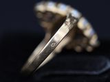 a close up of a gold ring with a diamond in it