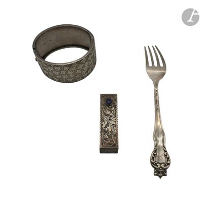a fork, knife, and ring sitting next to each other