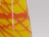 a yellow and red vase sitting on a table