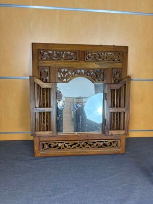 a mirror that is sitting on the floor in front of a mirror
