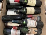 bottles of wine are in a cardboard box on a table