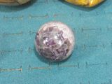 a glass ball sitting on top of a blue mat