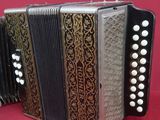 an image of a close up of an accordion on a red background