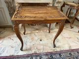 a small table with a wooden top on a tile floor