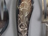 four different types of silverware on display on a table