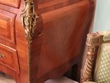 a wooden dresser with a marble top in a room