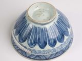 a blue and white bowl with a blue flower design on it