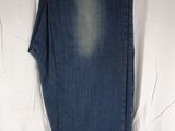 jeans hanging on a clothes hanger on a white sheet
