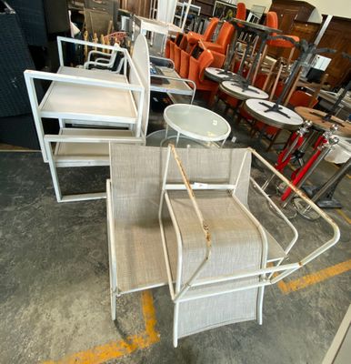 a lot of chairs and tables that are in a warehouse