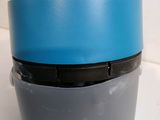 a blue lid on a gray cup on a white counter