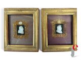 two framed pictures of a man and a woman in profile