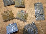 a lot of medals that are on a wooden table