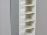 a white book shelf with many shelves in it