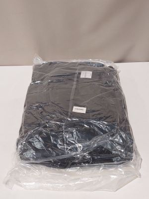 a bag of clothing wrapped in plastic on a table
