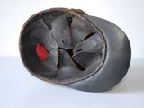 a black vase with a red heart in it
