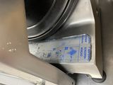 a box that is sitting on the floor next to a washing machine