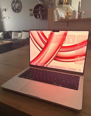a laptop computer sitting on a wooden table in a living room