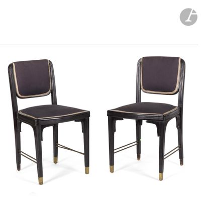 pair of black chairs with gold trimmings on the back