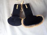 a pair of black shoes that are on a white surface