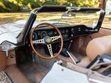 a dashboard and steering wheel of a car parked in a lot
