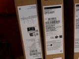 three boxes of acer products sit on a shelf in a store