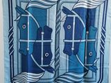 écharpe bleue et blanche sur laquelle figurent deux poissons dans une fenêtre