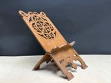 an old wooden stand with a carved design on it