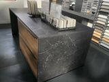 a marble counter top with a wooden drawer in the middle of it