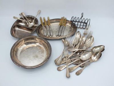 a lot of silver spoons and forks on the table