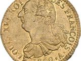a gold coin with an image of a man ' s head on it