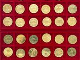 un gros plan sur une boîte rouge contenant de nombreuses pièces d'or