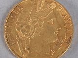 a close up of a gold coin on a white surface