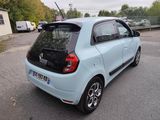 a small blue car parked in a parking lot
