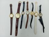 several different types of watches are lined up on a white surface