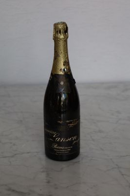 a bottle of champagne sitting on a marble table
