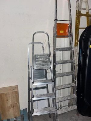 une valise noire posée à côté d'une échelle dans une pièce