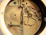 a close up of a clock that is on a table