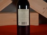 a bottle of wine sitting on a table next to a wooden box